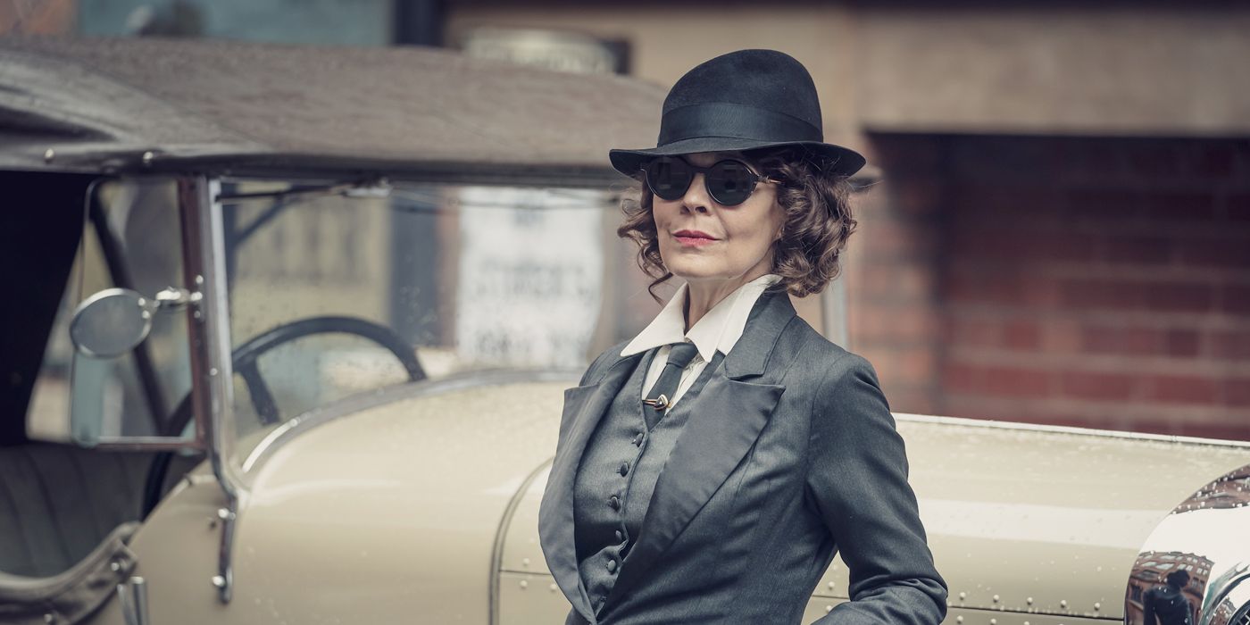 Polly Gray in a suit on the street in Peaky Blinders