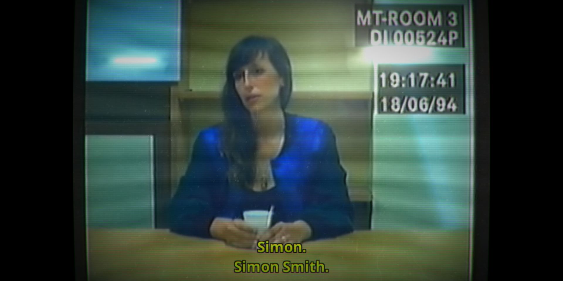 An image of a TV screen showing a woman confessing in the game Her Story.
