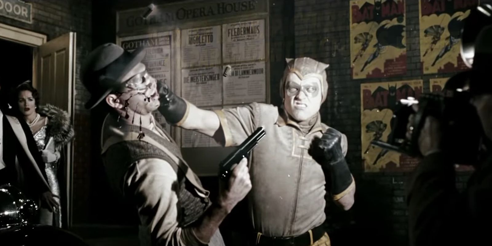 Hollis Mason as Nite Owl punching a criminal in Watchmen 2009
