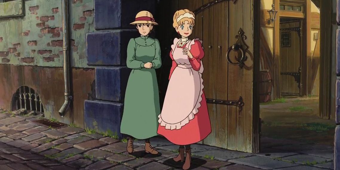 Lettie and Sophie stand in front of a gate in Howl's Moving Castle.