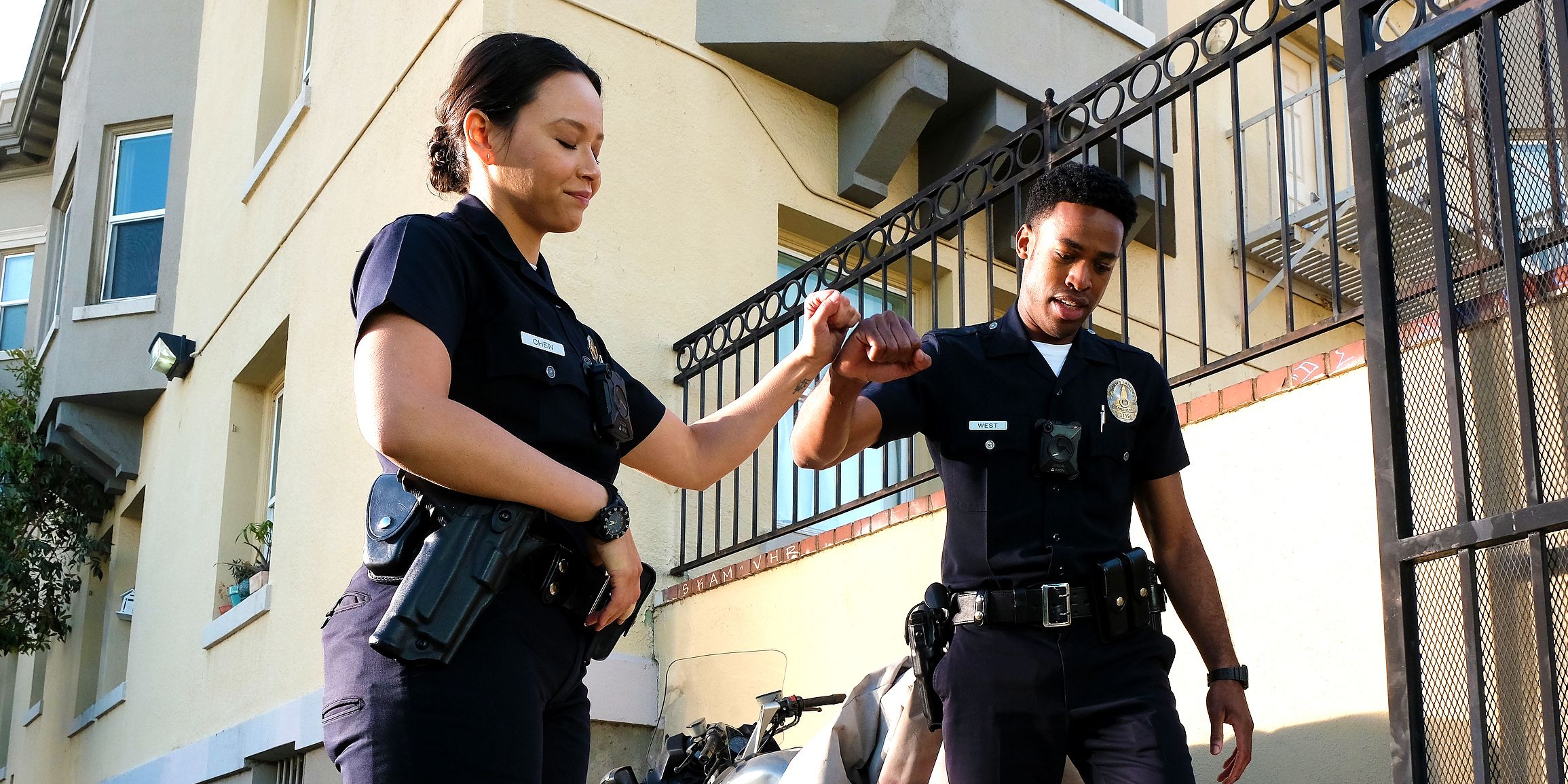 Jackson (Titus Makin Jr.) and Lucy (Melissa O'Neill) bumping fists in The Rookie.