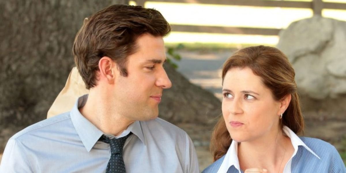 Jim Halpert and Pam Beesley from The Office smiling at each other