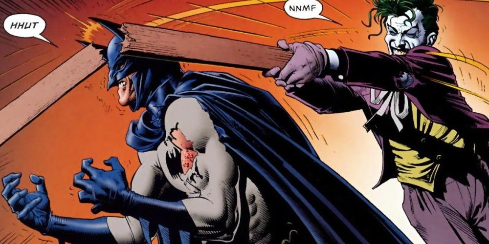Joker slamming a piece of wood on Batman&rsquo;s head