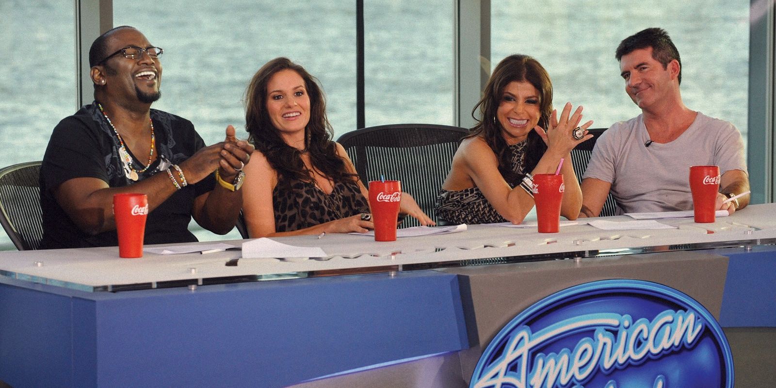 The judges of American Idol sitting at a table