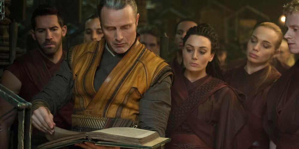 Kaecilius and the Zealots looking at the Book of Cagliostro in Doctor Strange (2016)