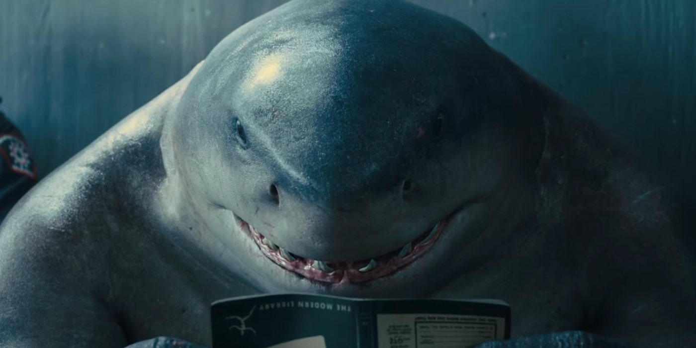 King Shark reading a book in prison