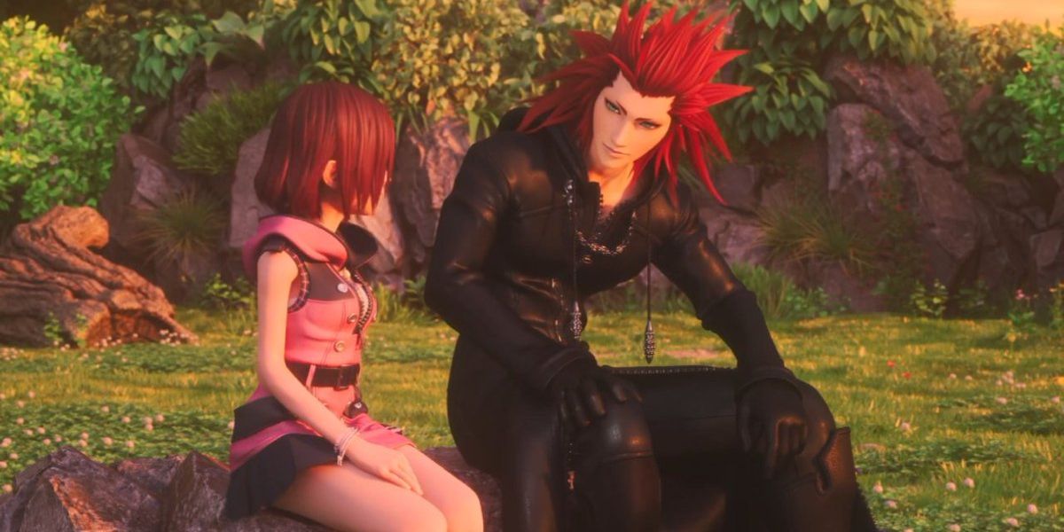 Sora and Kairi sit and talk in a park in Kingdom Hearts 2.