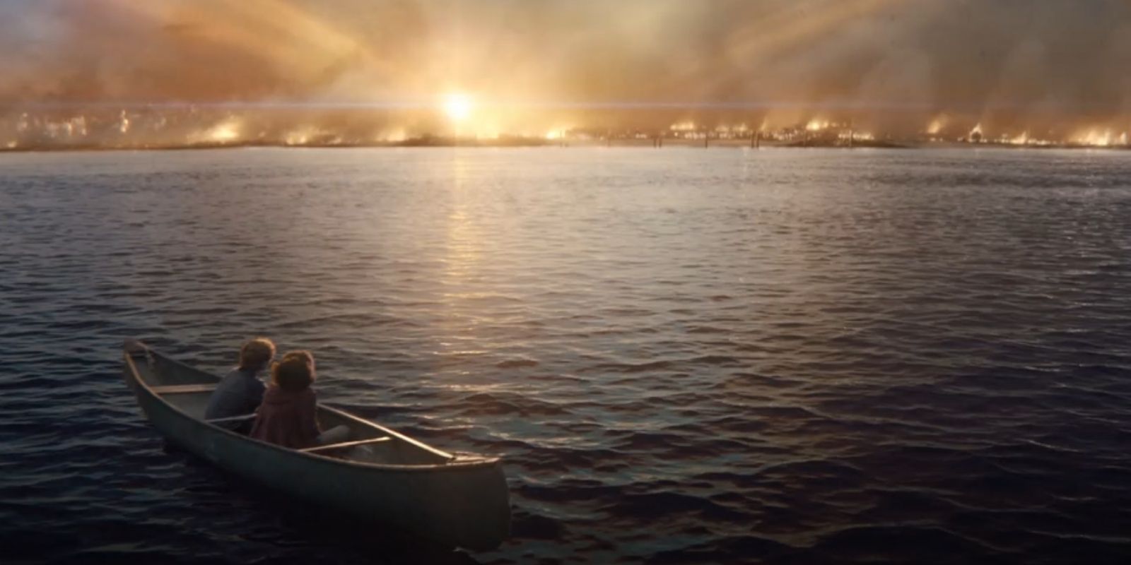 Leeza and Warren watch from a canoe as Crockett Island burns at sunrise in Midnight Mass.