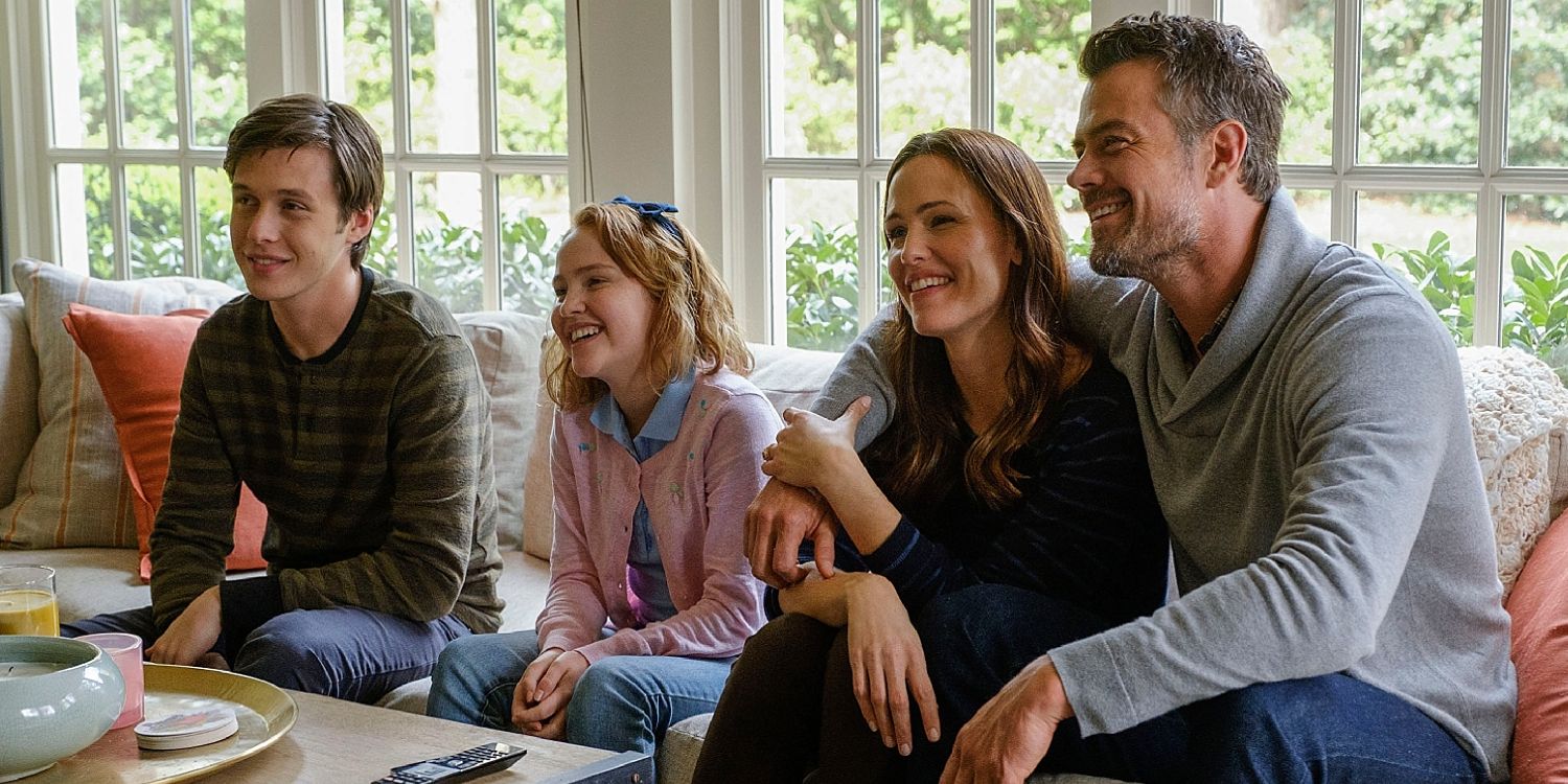 Simon sits with his family on the couch in Love, Simon.