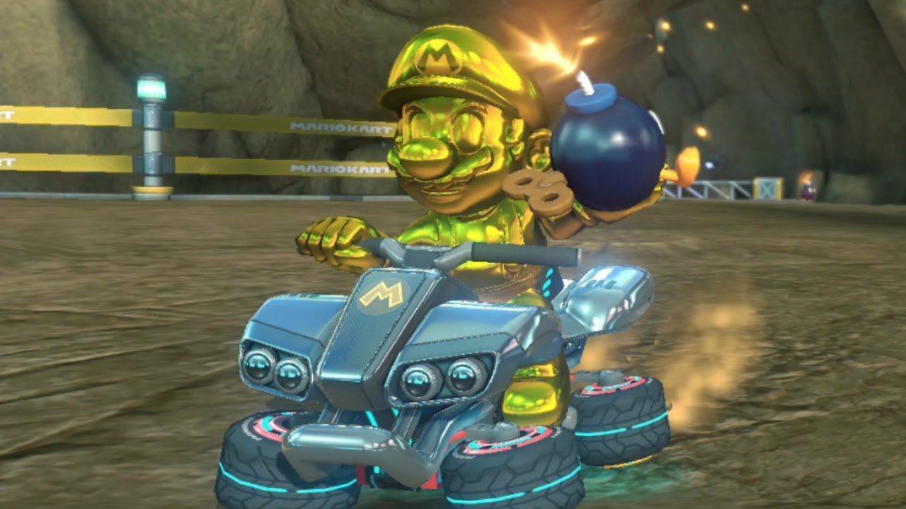 Golden Mario holding a Bomb-Omb in Mario Kart 8.