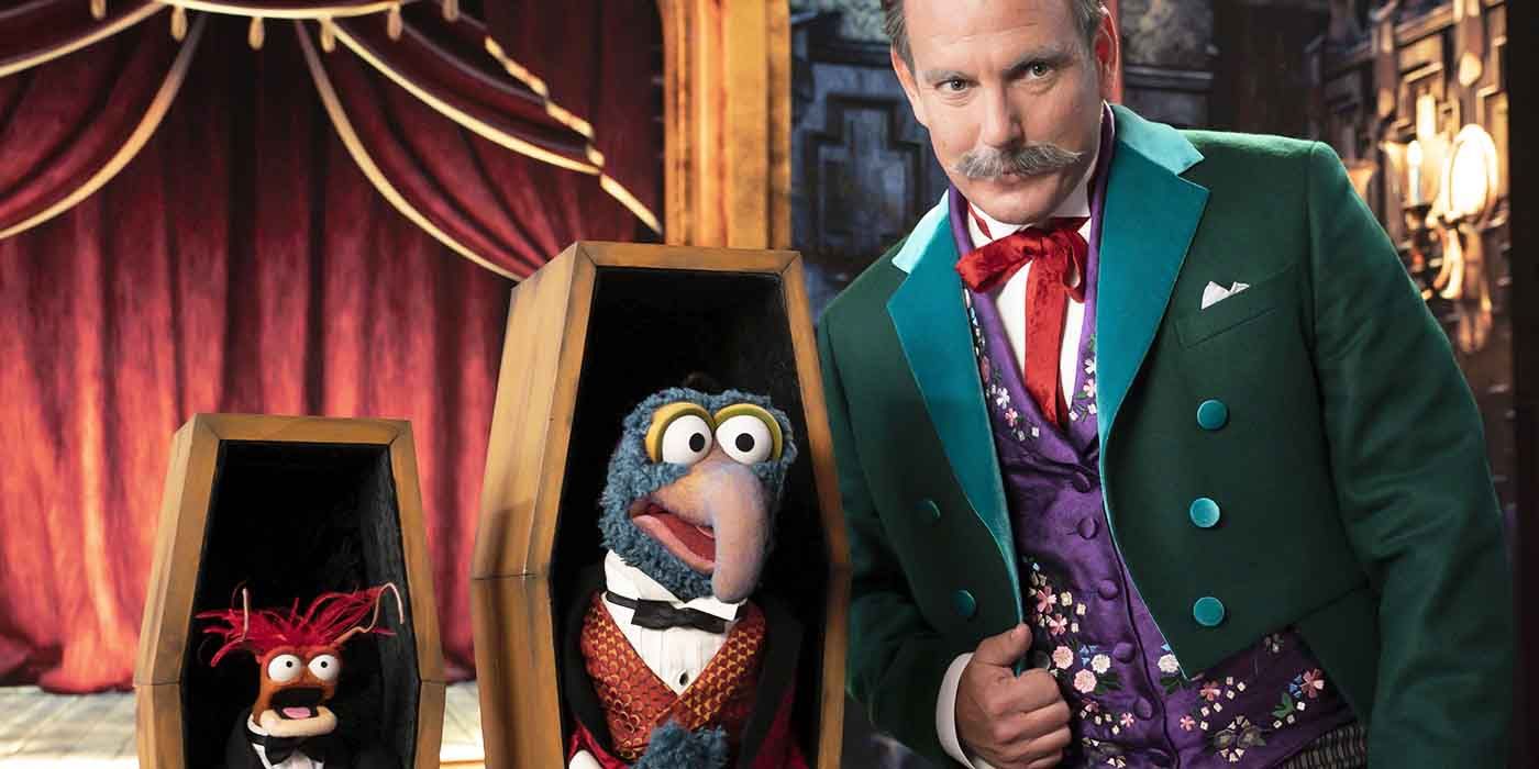 Will Arnett stands beside Pepe the King Prawn and Gonzo the Great in Muppets Haunted Mansion
