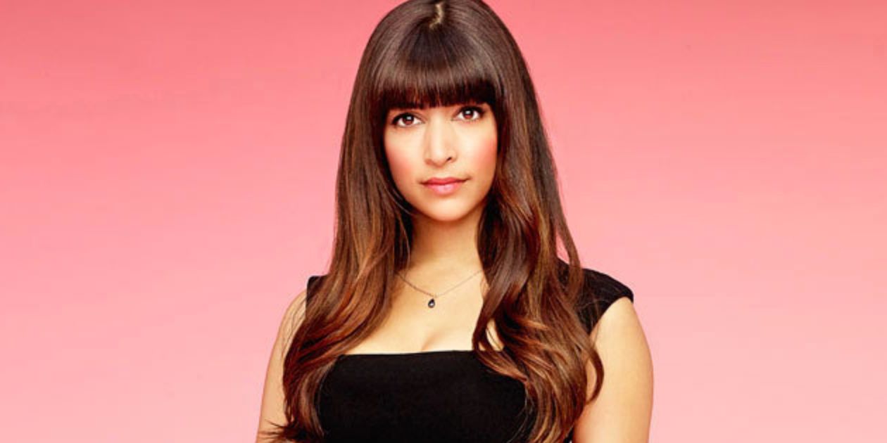 Hannah Simone as Cece in New Girl poses against a pink background