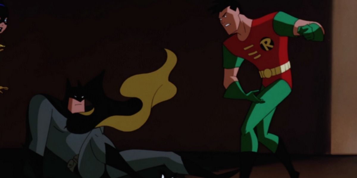 Dick Grayson throws his cape and mask at Batman.