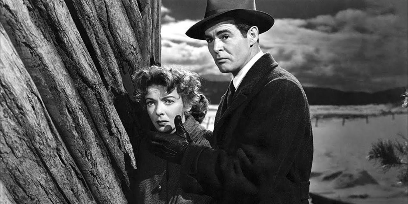 Louise and Howard hiding behind a cliff in the movie, On Dangerous Ground