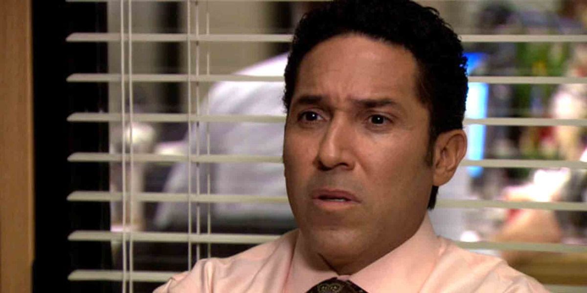 Oscar from The Office looking offended in Michael's office