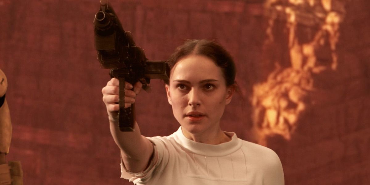 Padme Amidala from Star Wars holding a gun up to the sky