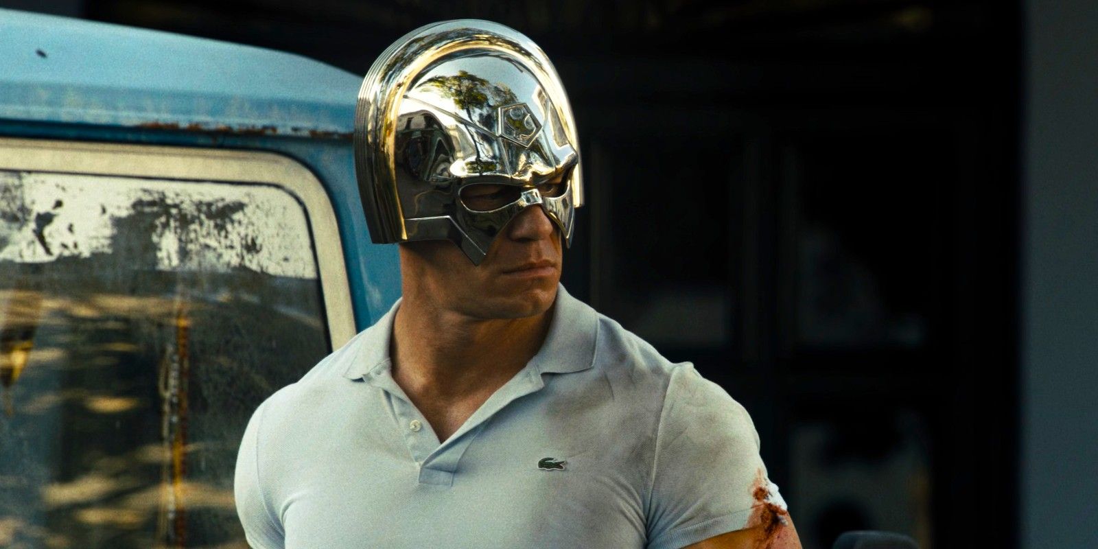 Peacemaker wears his helmet and a Lacoste polo shirt in The Suicide Squad 