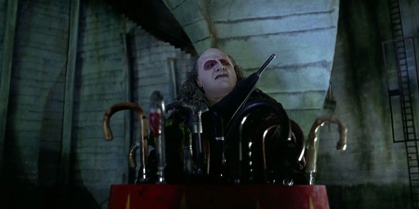 Penguin selects an umbrella in his sewer lair in Batman Returns.