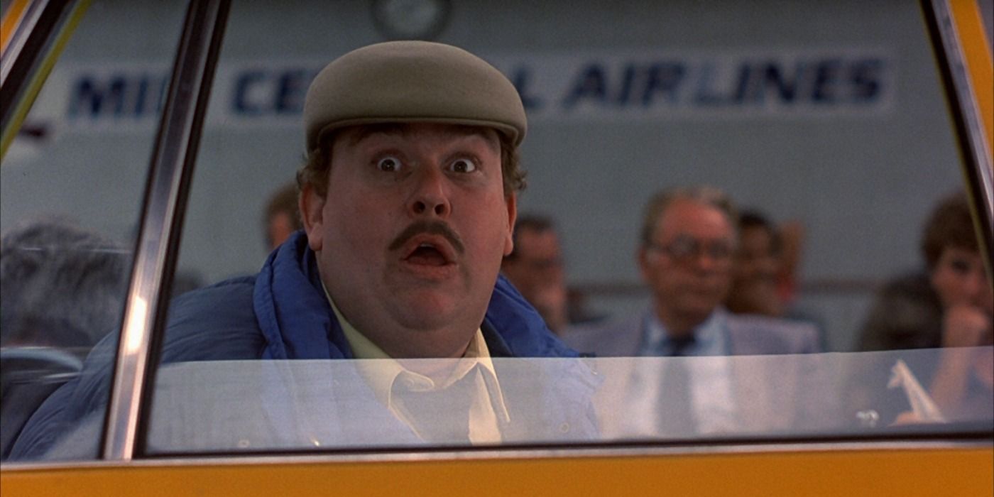 Del looking surprised in a taxi in Planes, Trains and Automobiles