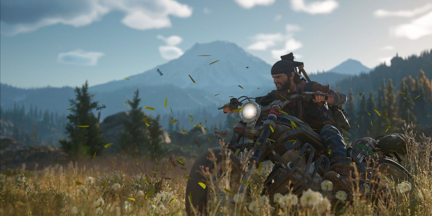 Deacon rides his bike through a green field in Days Gone