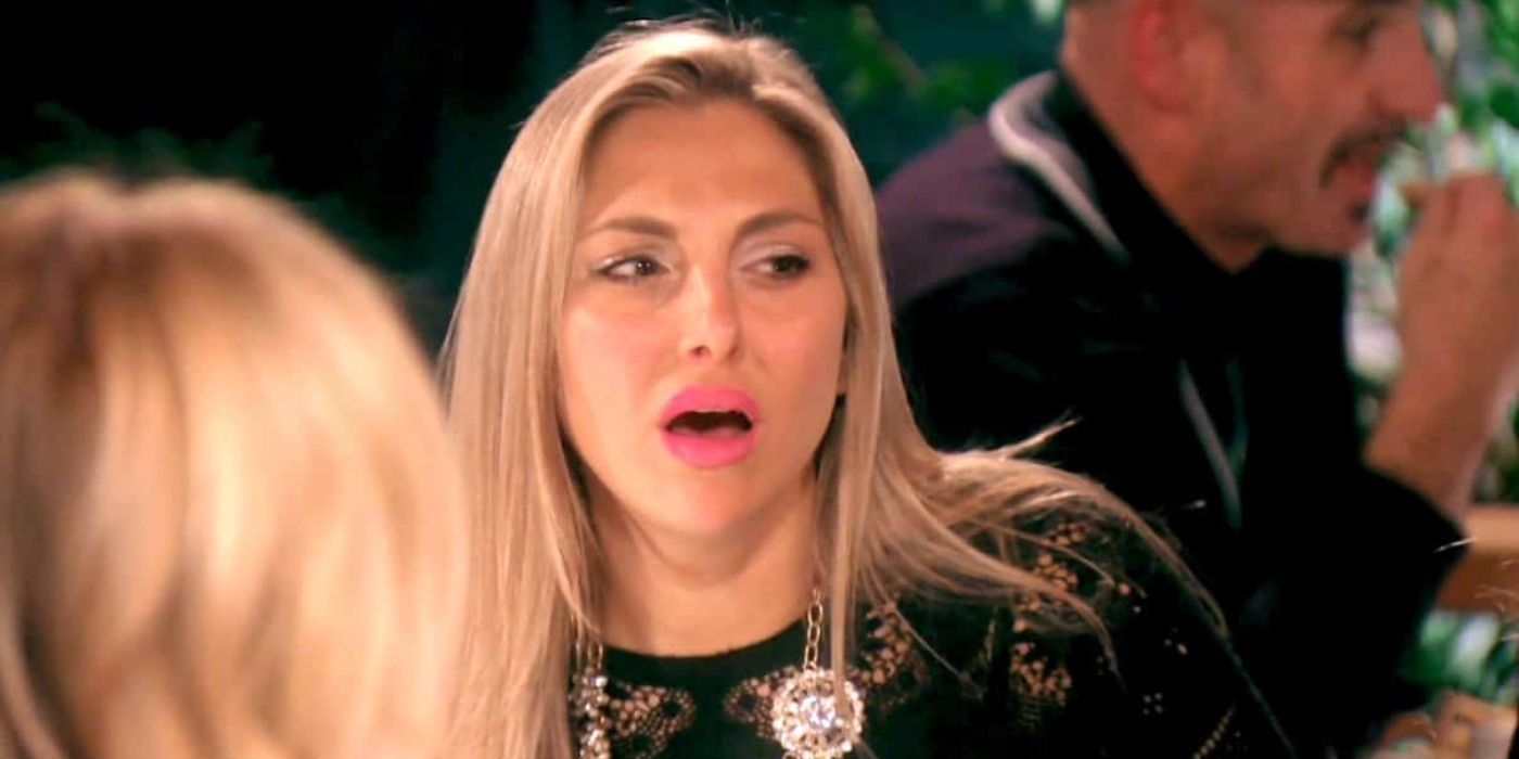 Gina looking upset and surprised at dinner on RHOC