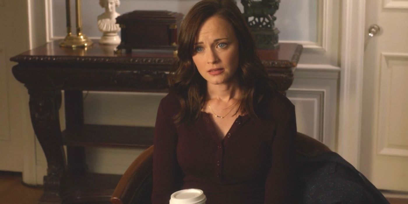 Rory sitting in an office with a cup of coffee on Gilmore Girls A Year in the Life.