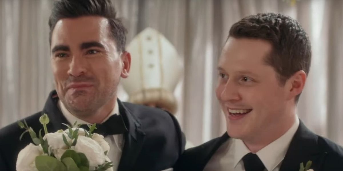 Patrick and David on their wedding day smiling in Schitt's Creek