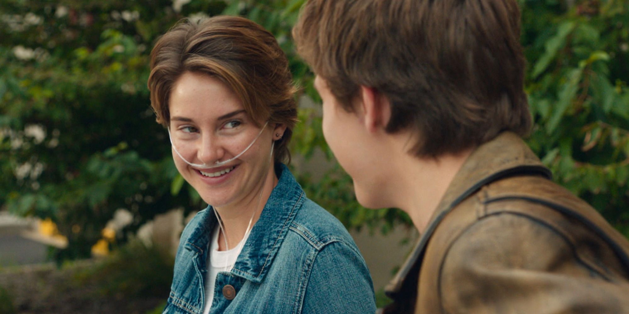 Shailene Woodley with a nasal cannula sitting with Ansel Elgort in The Fault in Our Stars