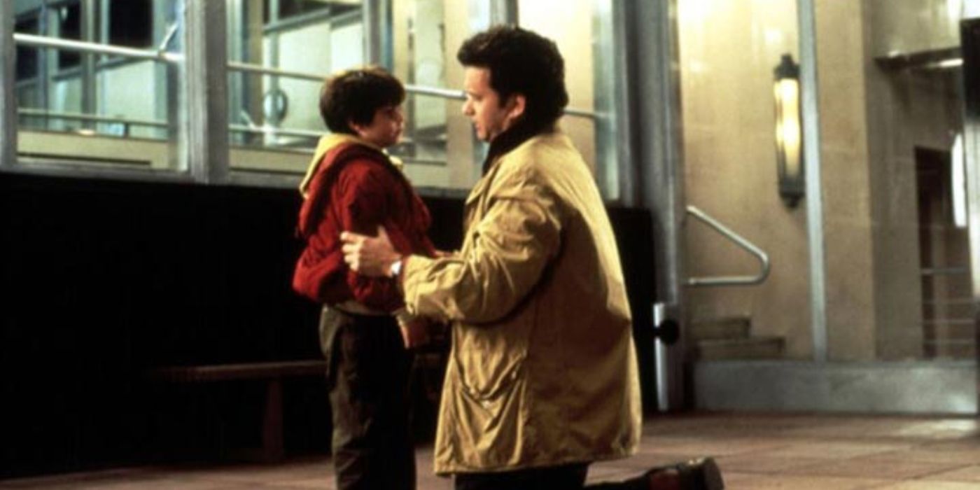 Sam kneeling on the ground talking to his son Jonah in Sleepless In Seattle