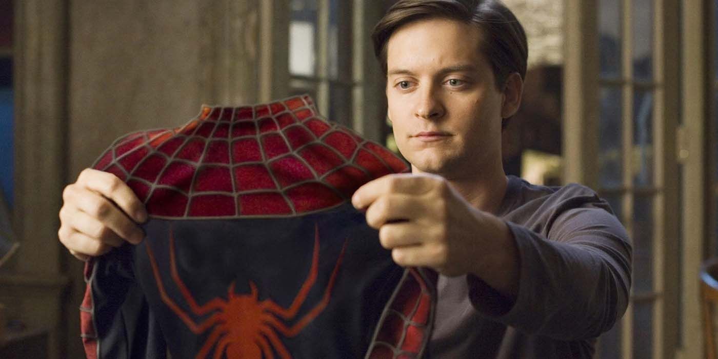 Tobey Maguire holding his suit as Spider-Man