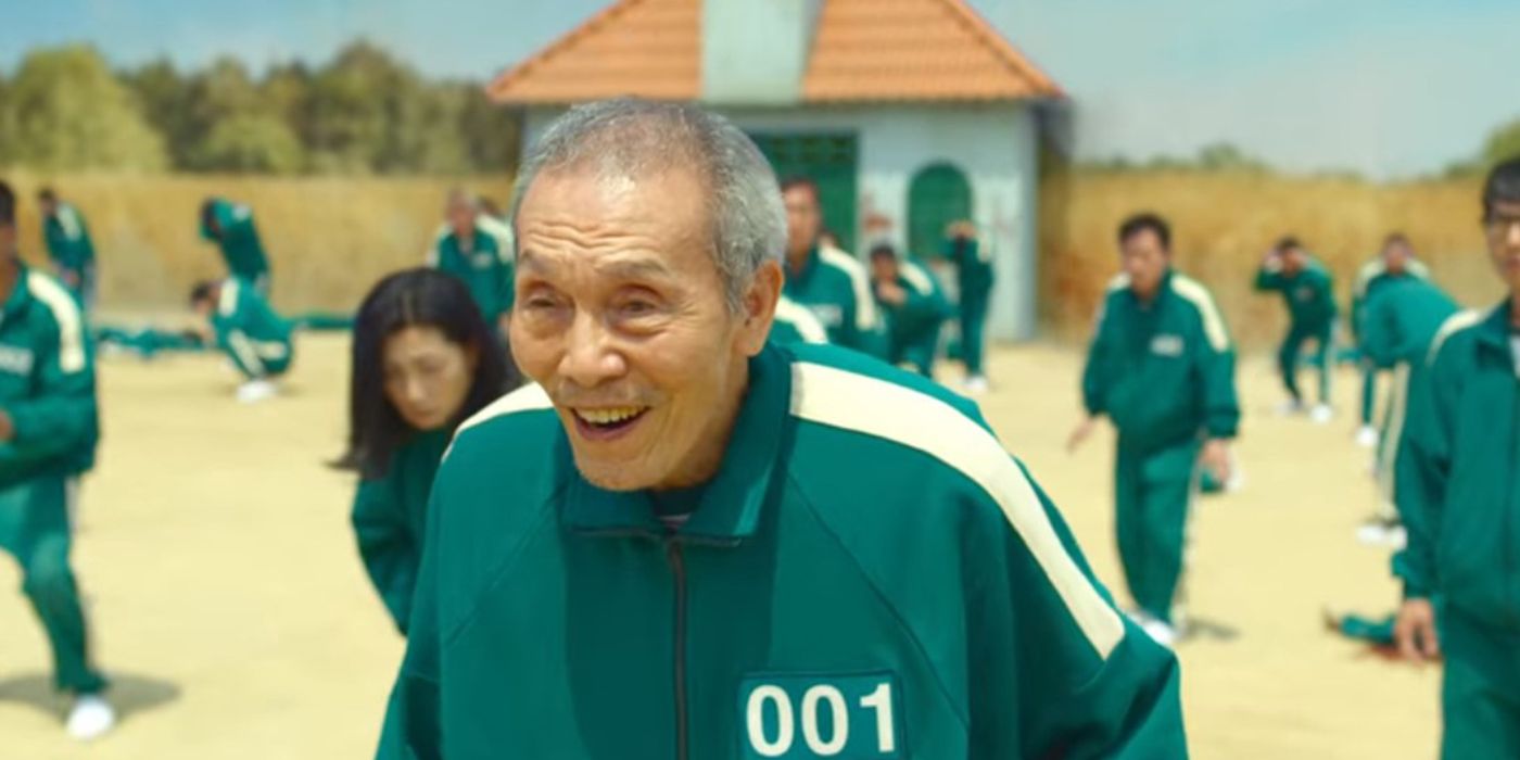 Il-Nam smiles in an outside area with other players in the Netflix show Squid Game.