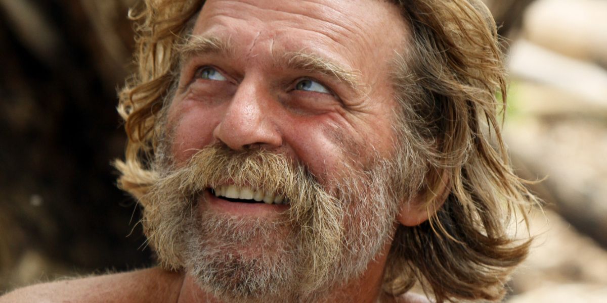 Close-up of Tarzan grinning and looking at something off-camera on Survivor