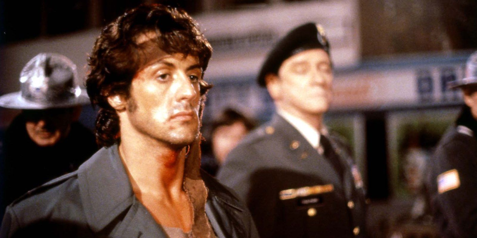 Sylvester Stallone looking somber in the final scene of First Blood