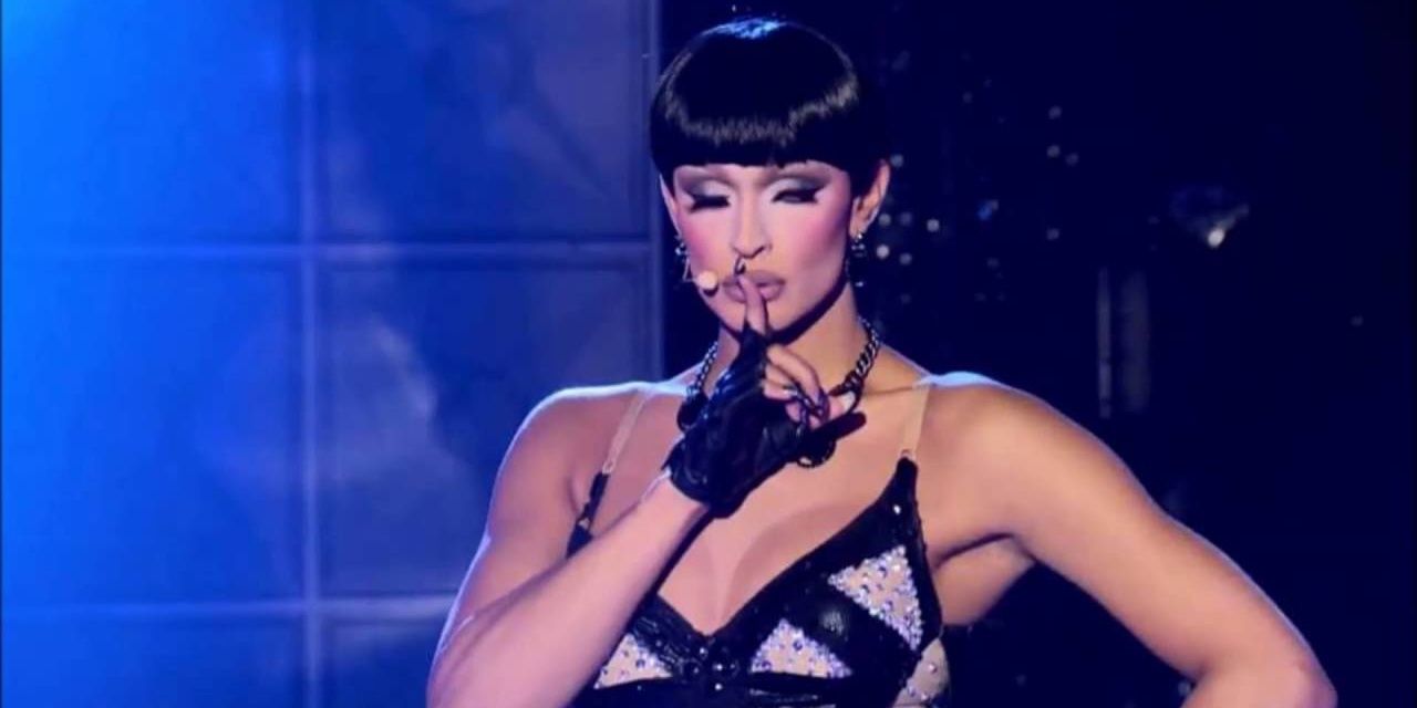 Tatianna pointing a finger on her lips while performing Same Parts Cropped