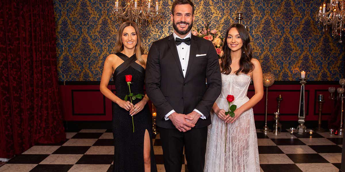 Contestants stand nest to the bachelor in The Bachelor Australia.