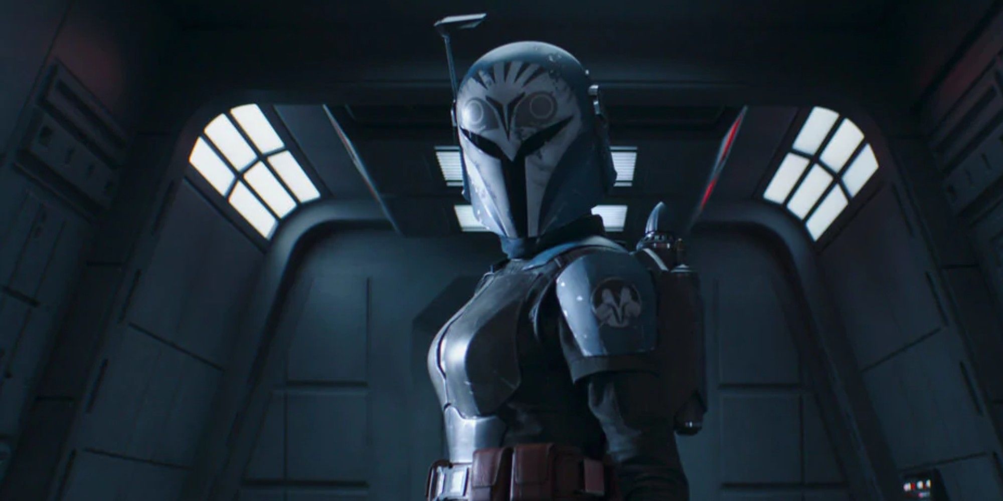 Bo-Katan Kryze in The Mandalorian, looking ahead, arm outstretched.