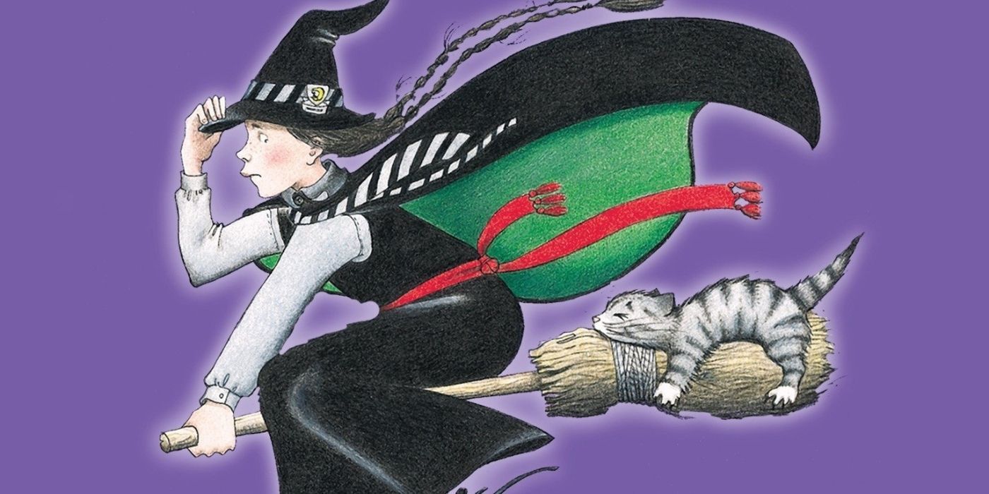 A young witch flying in a broom holding her hat