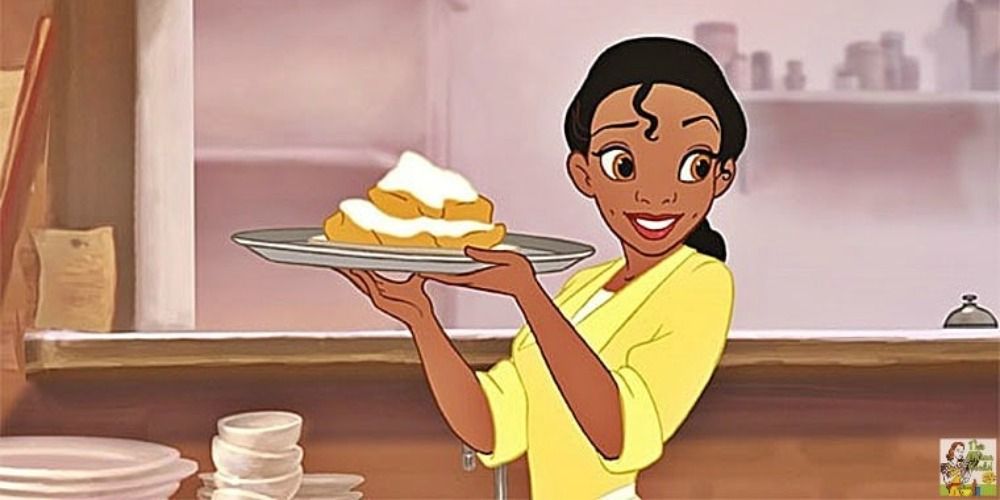 Tiana holding beignets in her hand in The Princess and The Frog