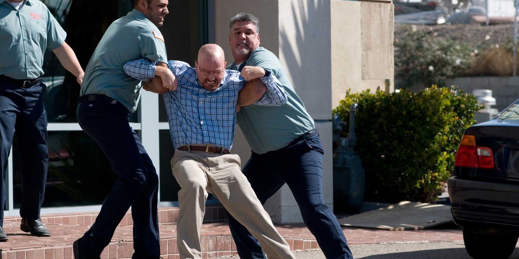 Walt being escorted from Ted's office in Breaking Bad