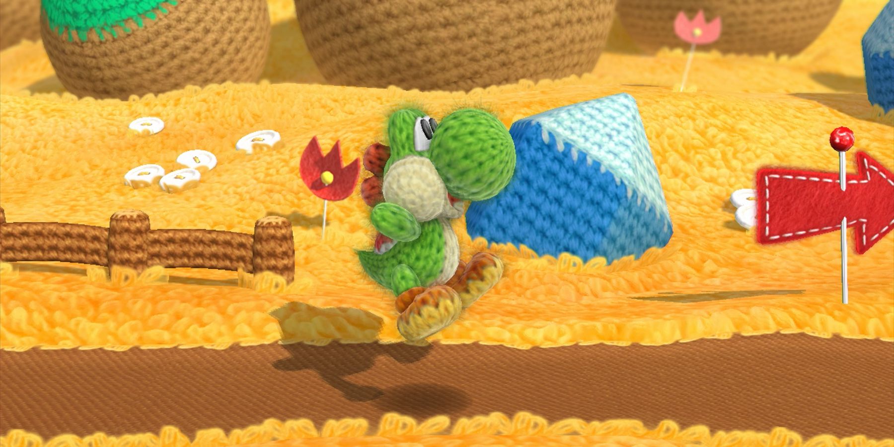 Yarn Yoshi hopping with joy in Yoshi's Woolly World