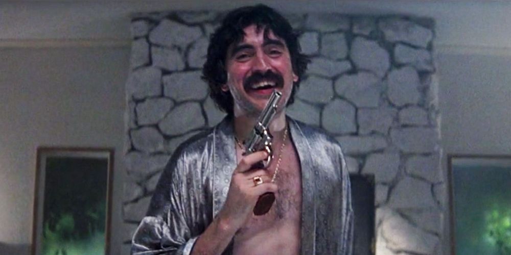 Rahad holds up a gun to his chin in Boogie Nights.