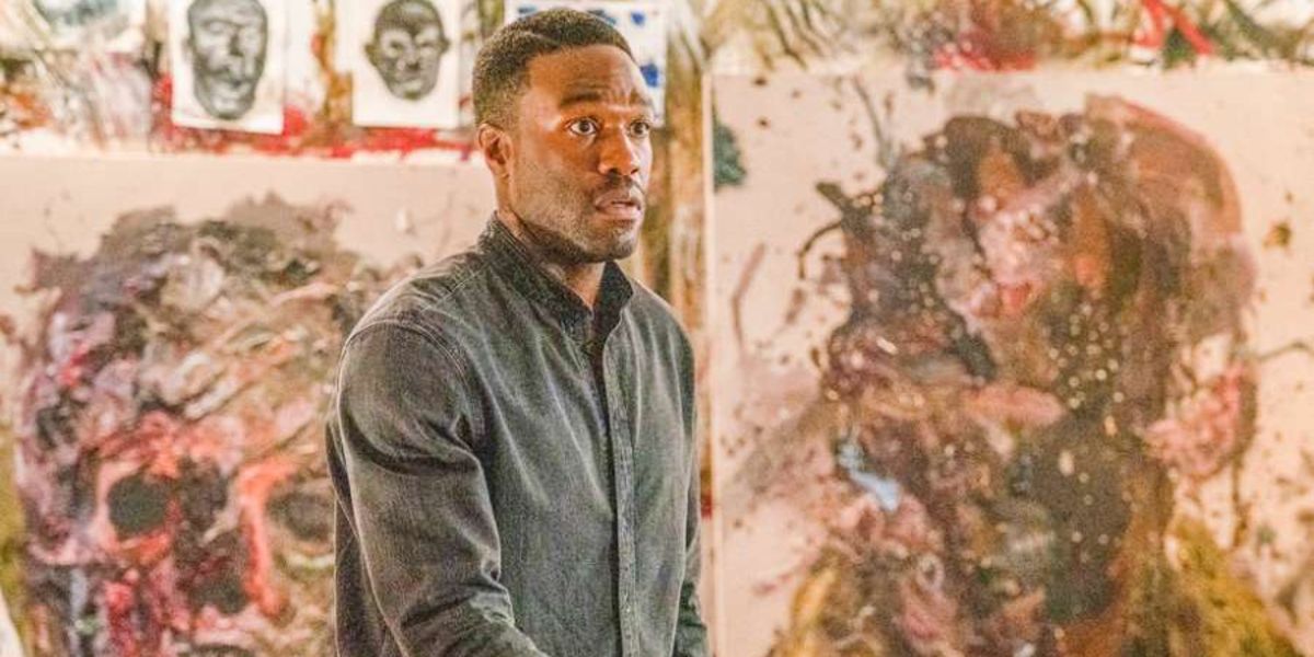 Anthony McCoy (Yahya Abdul-Mateen II) surrounded by his paintings in his studio in Candyman (2021)
