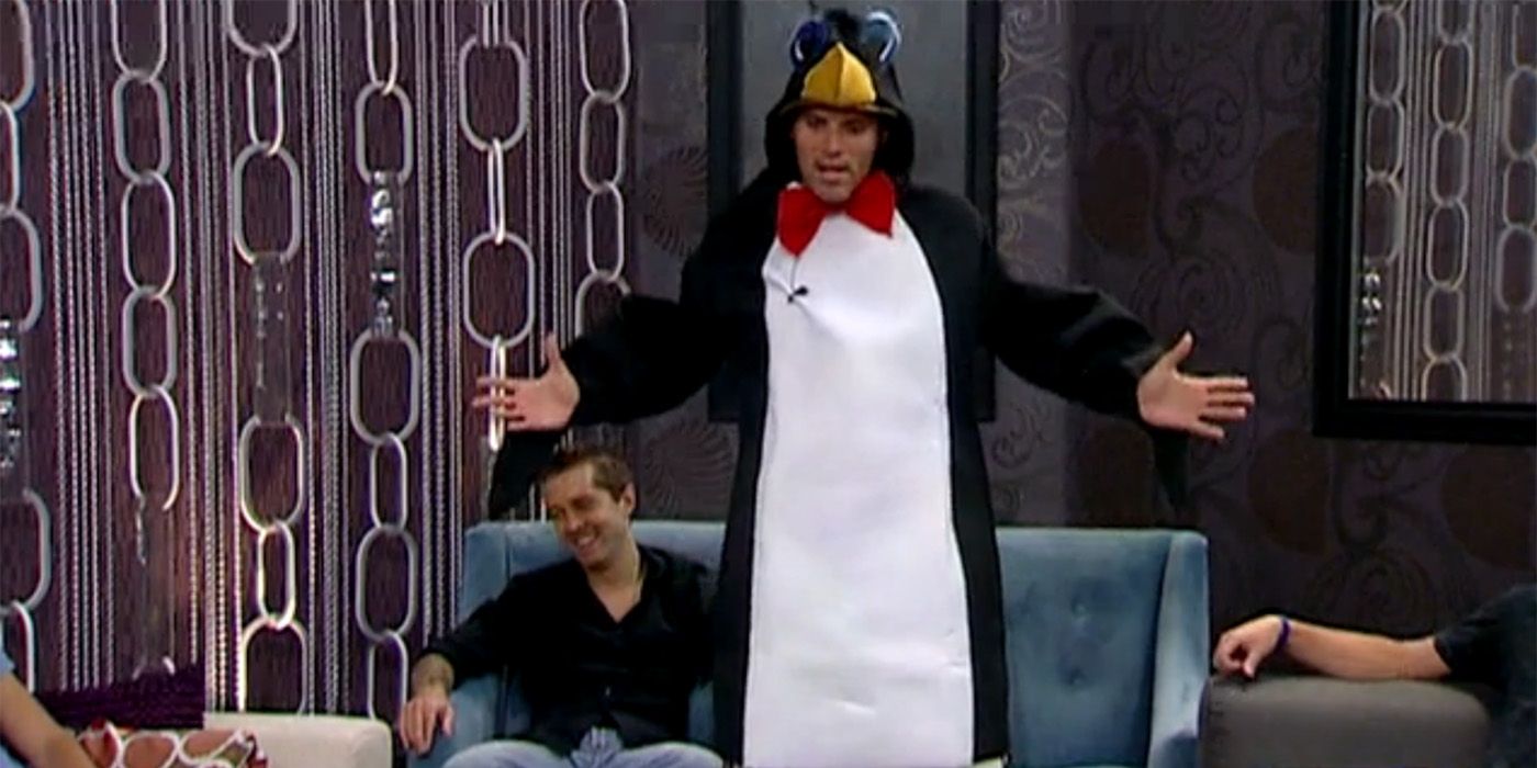 Enzo dressed as a penguin on Big Brother, standing up with his arms outstretched.