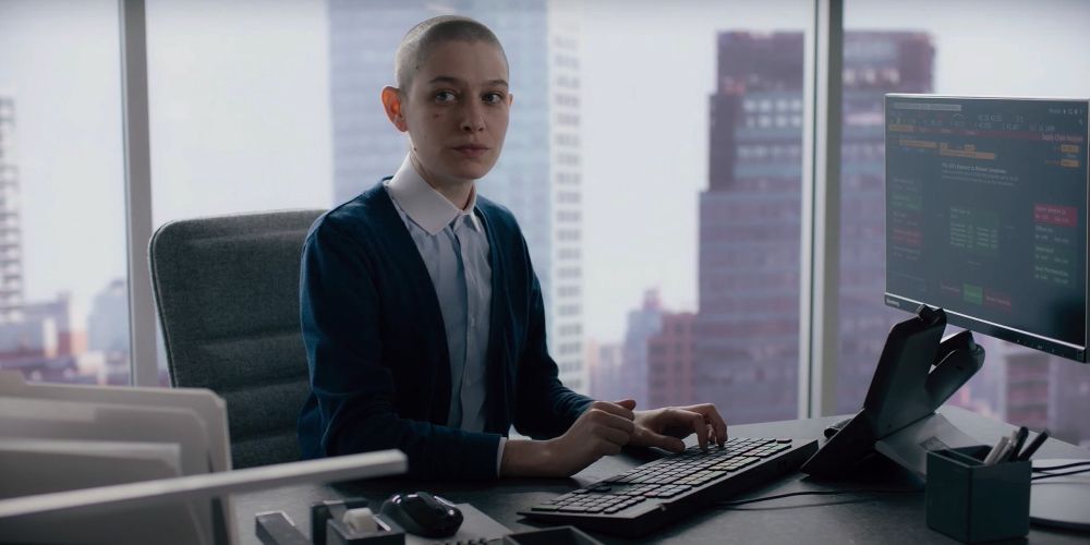 Taylor sits at their desk in a high rise on Billions