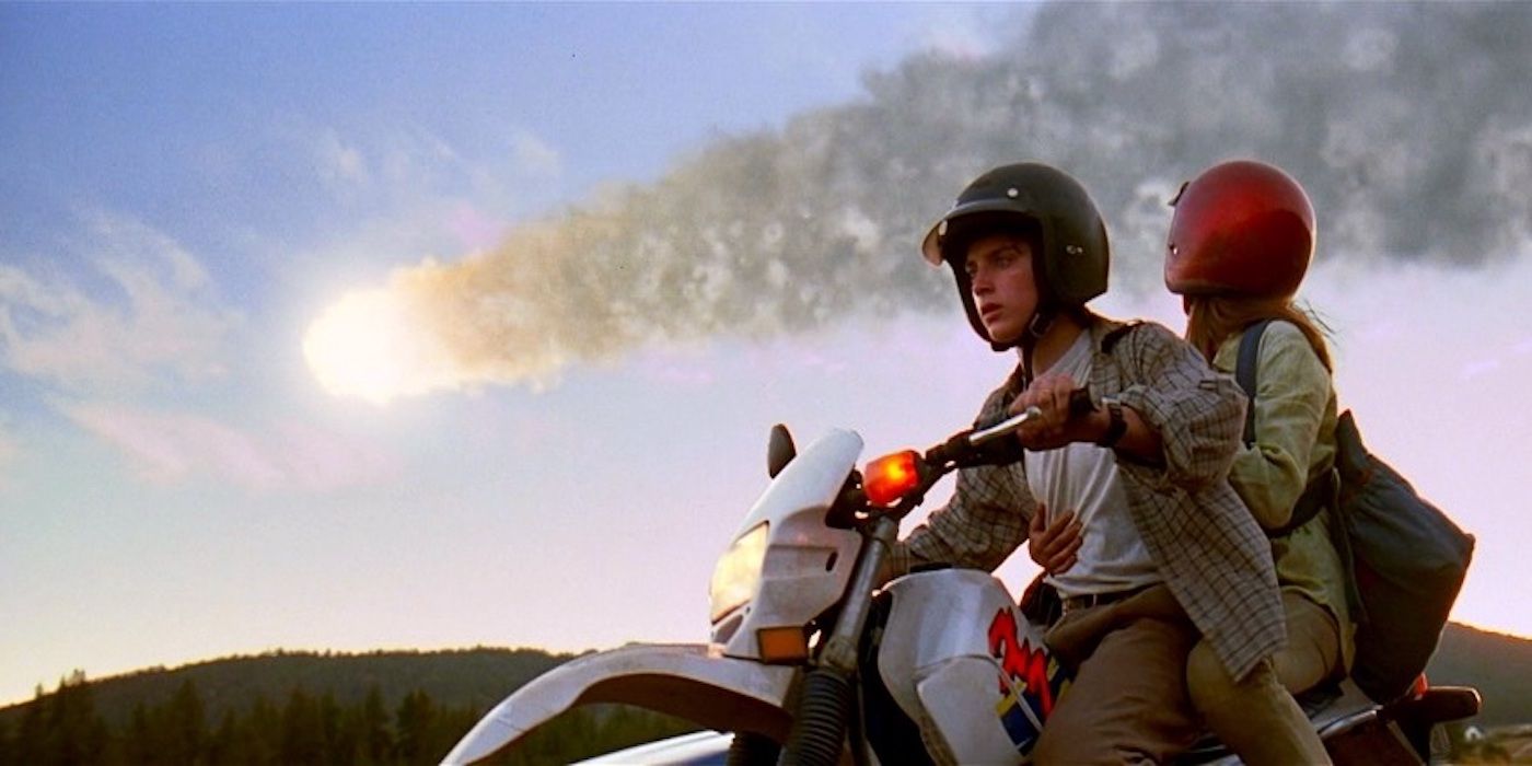 A man and a woman on a motorcycle in the foreground and a comet in the background in Deep Impact.