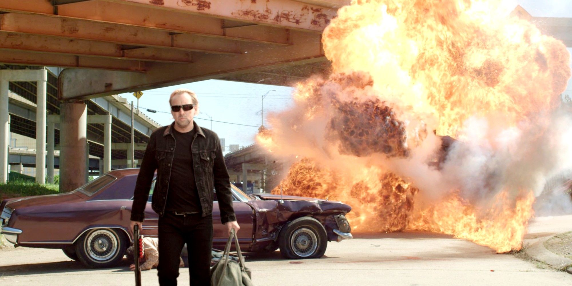 John walks away from an explosion in Drive Angry