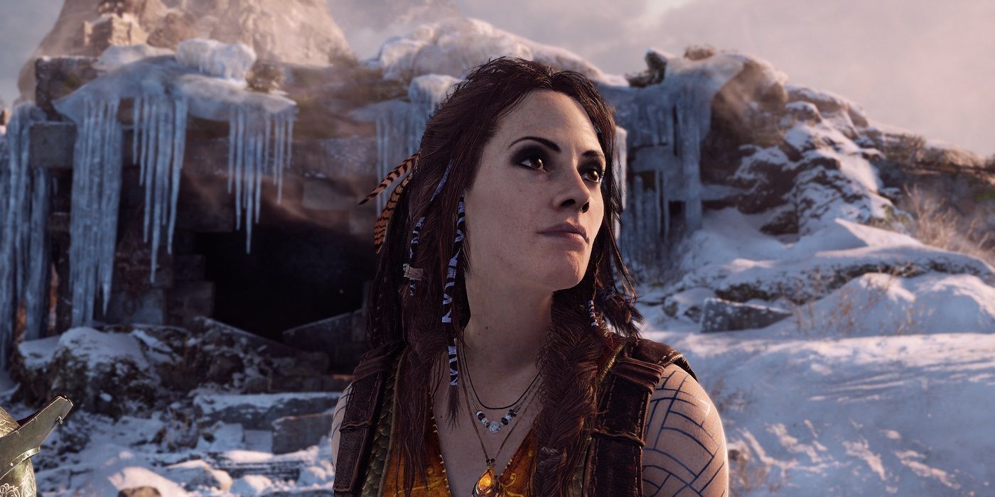 Freya looking up while standing in front of a frozen cavern in God of War.