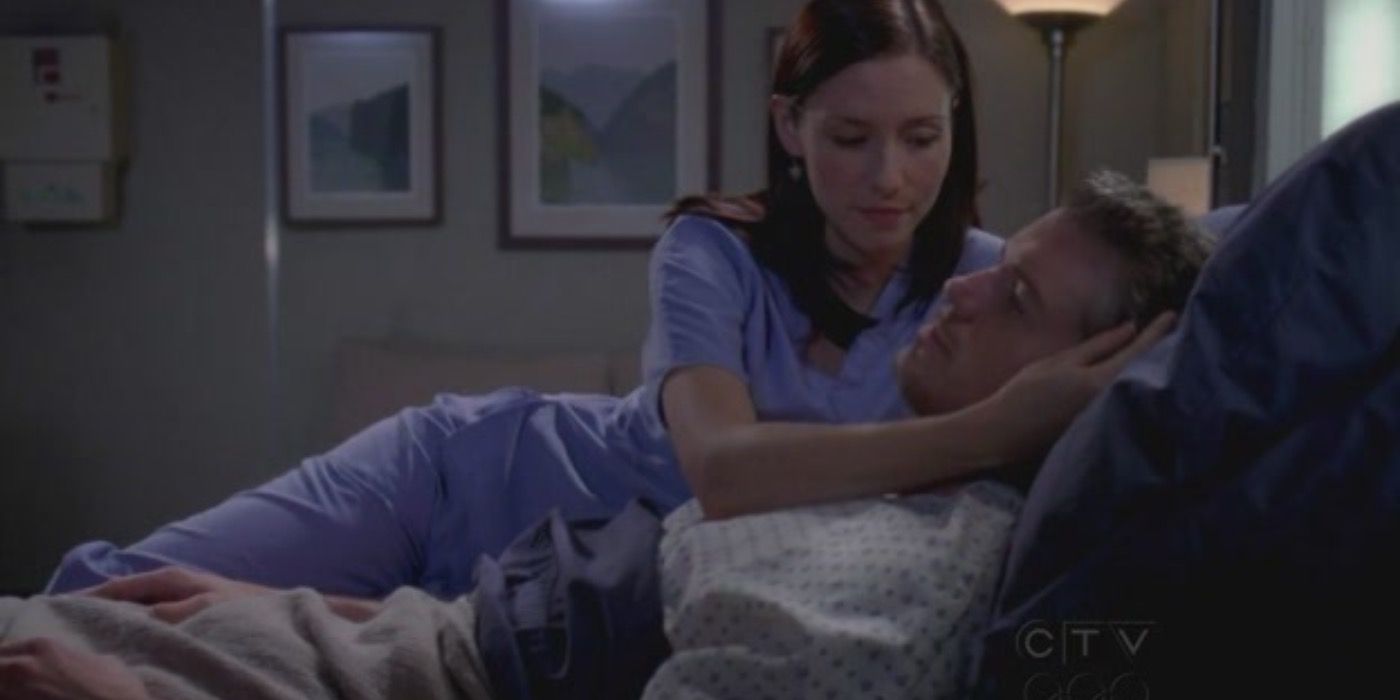 Lexie comforting Mark in the hospital bed on Grey's Anatomy