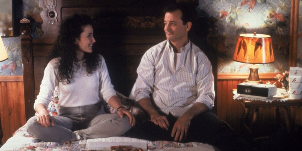 Rita and Phil eat pizza in bed in Groundhog Day