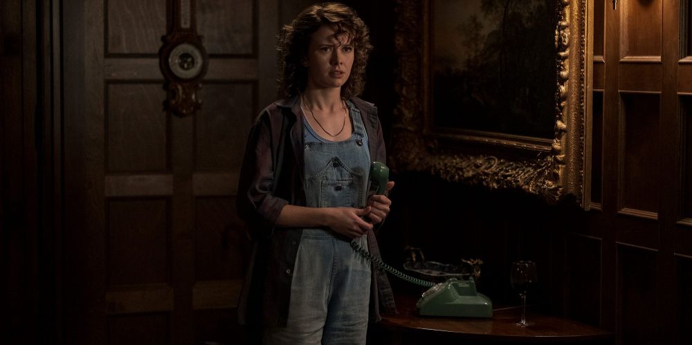 Jamie holds telephone receiver on The Haunting of Bly Manor